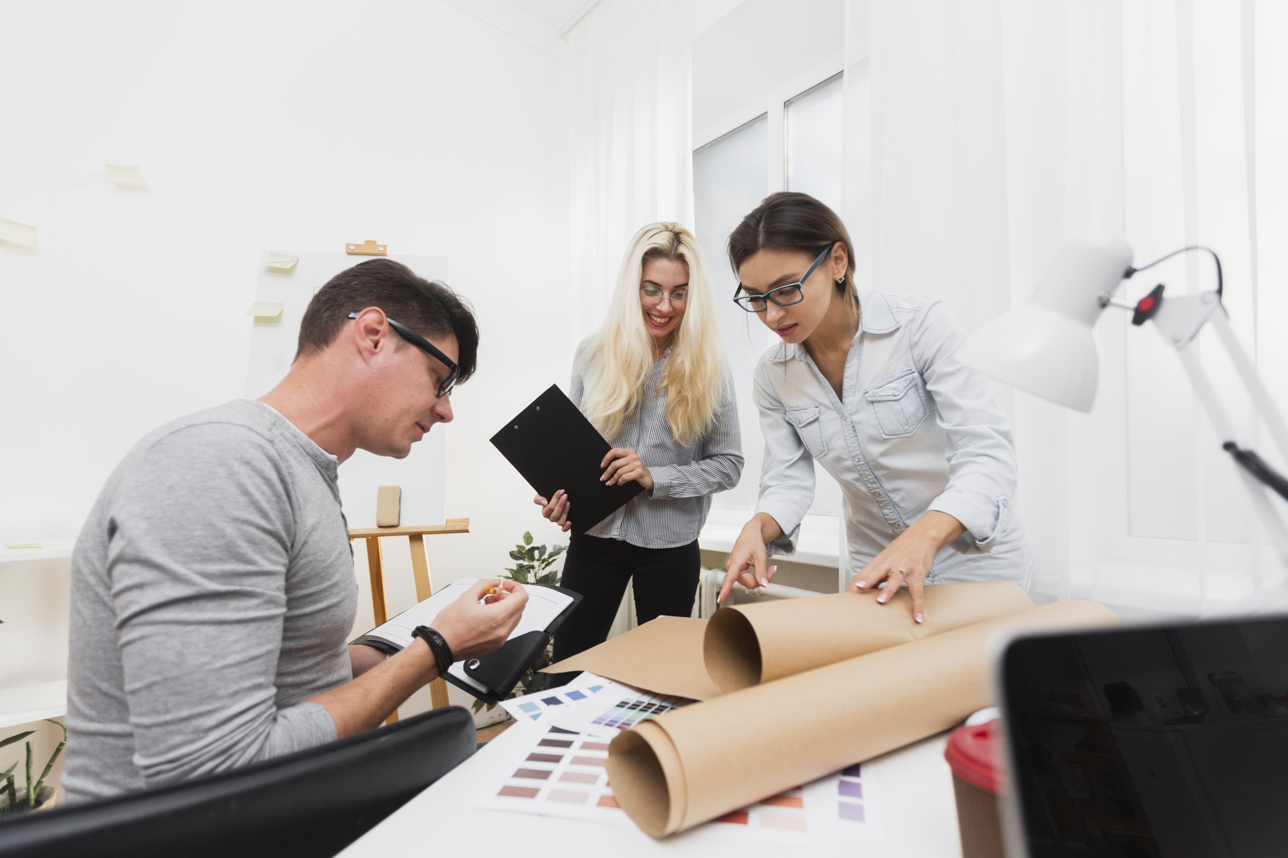 business-colleagues-looking-cardboard-sheet